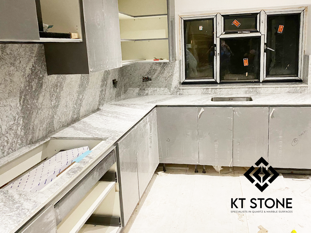 Polished stone worktop and matching splashback detail — KT Stone London