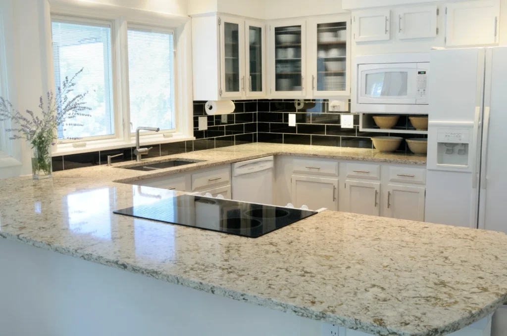 Natural granite worktop in a bright fitted kitchen